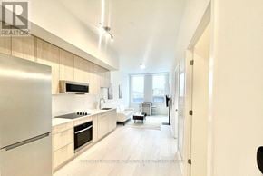 Oakville (Ga Glen Abbey) condo for rent - A modern kitchen with wooden cabinets and stainless steel appliances.