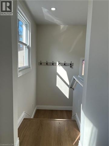 Hamilton apartment for rent - A room with a window and a wooden floor.