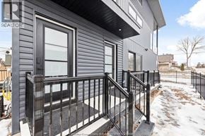 Windsor apartment for rent - A realtor photo of a house with a black railing and steps.