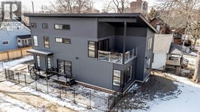 Windsor apartment for rent - A grey house with a black fence in front of it.