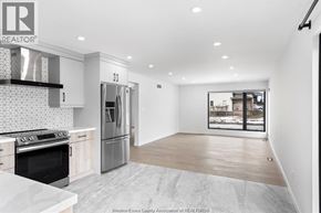 Windsor apartment for rent - A kitchen with a refrigerator, oven, and sink.