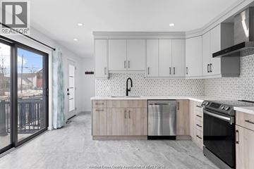Windsor apartment for rent - A kitchen with white cabinets and a black stove top oven.