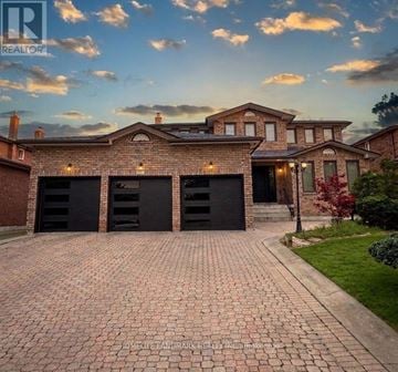 Markham (Milliken Mills East) apartment for rent - A large house with a brick driveway and a garage.