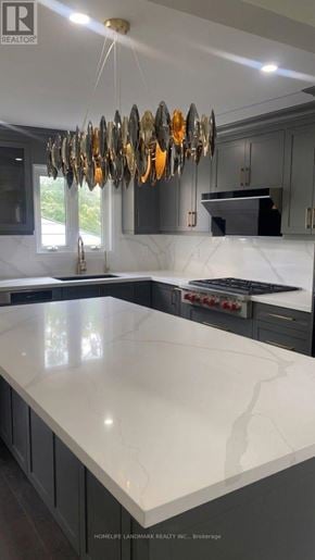 Markham (Milliken Mills East) apartment for rent - A modern kitchen with a marble countertop and a chandelier.