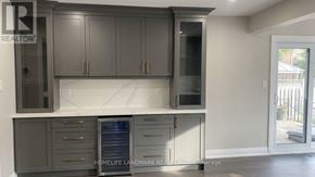 Markham (Milliken Mills East) apartment for rent - A kitchen with dark grey cabinets and a white countertop.