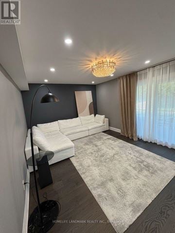 Markham (Milliken Mills East) apartment for rent - A well-lit living room with a white sofa and a grey rug.