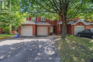 Ottawa townhouse for rent - A house with a tree in front and a car parked in the driveway.