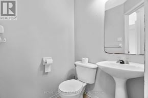 Ottawa townhouse for rent - A white toilet and sink in a bathroom.