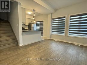 Welland (N. Welland) house for rent - A room with wooden floors and a staircase leading to the upper level.