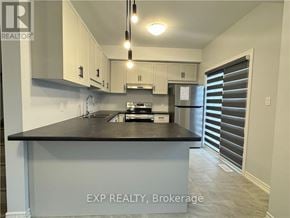 Welland (N. Welland) house for rent - A kitchen with EXP Realty Brokerage written on the island.