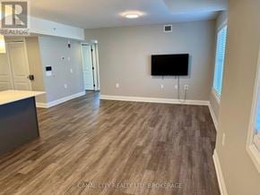 Thorold (Thorold Downtown) apartment for rent - A room with wooden flooring and a flat screen TV mounted on the wall.