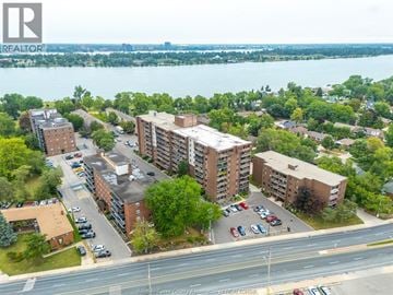 Windsor condo for rent - A bird's eye view of a residential area with apartment buildings and cars parked in front.
