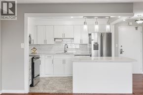 Windsor condo for rent - A modern kitchen with white cabinets and appliances.