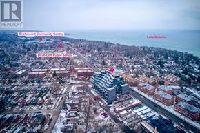 Toronto (Birchcliffe-Cliffside) condo for rent - An aerial view of a city with a large building in the center and a road running through it.