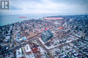 Toronto (Birchcliffe-Cliffside) condo for rent - A real estate company logo is superimposed on an aerial view of a residential area with a golf course.