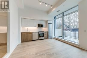 Toronto (Birchcliffe-Cliffside) condo for rent - A spacious kitchen with wooden cabinets and stainless steel appliances.