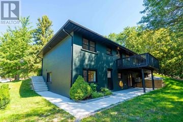 Newmarket (Gorham-College Manor) apartment for rent - A house with a green exterior and a balcony on the second floor.