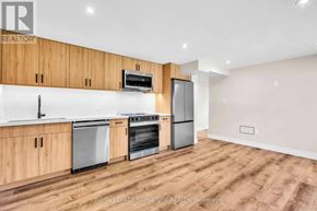 Newmarket (Gorham-College Manor) apartment for rent - A kitchen with wooden cabinets and stainless steel appliances.
