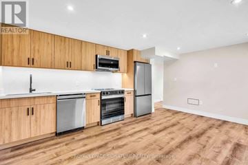 Newmarket (Gorham-College Manor) apartment for rent - A kitchen with wooden cabinets and stainless steel appliances.