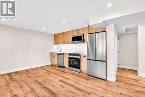 Newmarket (Gorham-College Manor) apartment for rent - A kitchen with a refrigerator, oven, and microwave.