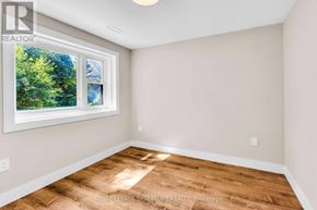 Newmarket (Gorham-College Manor) apartment for rent - A room with a window and wooden flooring.
