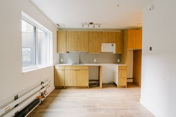 Edmonton apartment for rent - A kitchen with wooden cabinets and a white countertop.