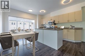 Milton condo for rent - A modern kitchen with a dining table and chairs.