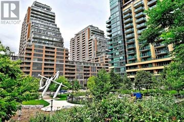 Toronto (Niagara) condo for rent - A cityscape with buildings and a sculpture in the foreground.