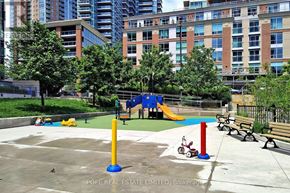 Toronto (Niagara) condo for rent - A playground with a slide, swings, and a seesaw.