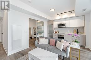 Toronto (Islington-City Centre West) condo for rent - A modern living room with a grey couch and a coffee table.