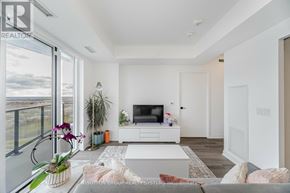 Toronto (Islington-City Centre West) condo for rent - A living room with a television and a view of the outdoors.