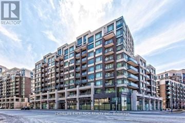 Markham (Unionville) condo for rent - A large, modern building with many windows is the focus of this image.