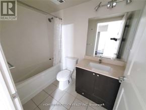 Markham (Unionville) condo for rent - A white bathroom with a toilet, sink, and shower.