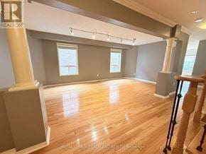 Richmond Hill (Westbrook) apartment for rent - A spacious room with wooden floors and a staircase on the right side.