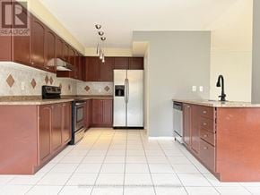 Richmond Hill (Westbrook) apartment for rent - A kitchen with brown cabinets and a white refrigerator.