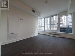 Markham (Unionville) condo for rent - A large, empty room with a window overlooking a cityscape.