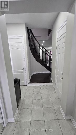 Brampton (Northwest Brampton) apartment for rent - A hallway with a staircase and a black trash can.