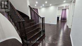 Brampton (Northwest Brampton) apartment for rent - A staircase with a wooden banister and a white wall.