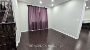 Brampton (Northwest Brampton) apartment for rent - A room with a purple curtain and wooden flooring.