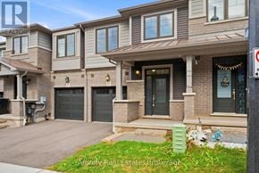 Cambridge townhouse for rent - A house with a garage and a driveway in front of it.