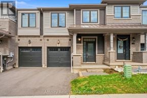 Cambridge townhouse for rent - A modern two-story house with a garage and a front porch.