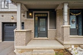 Cambridge townhouse for rent - A house with a black door and a sign that says "REALTOR" on the wall.
