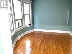 Toronto (South Riverdale) apartment for rent - A room with wooden floors and a window.
