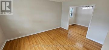 Oakville (Co Central) apartment for rent - A room with wooden flooring and white walls, with a small window and a doorway leading to another room.