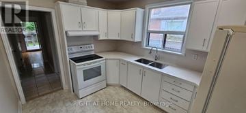 Oakville (Co Central) apartment for rent - A kitchen with white cabinets and appliances is for sale.