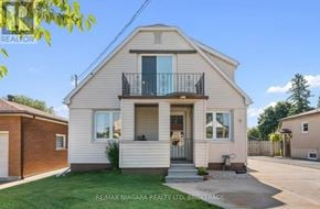 Thorold (Thorold Downtown) apartment for rent - A two-story house with a balcony on the second floor is for sale.