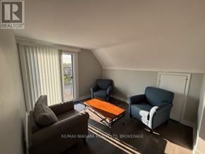 Thorold (Thorold Downtown) apartment for rent - A living room with a brown couch, a blue chair, and a coffee table.