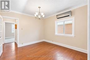 Thorold (Thorold Downtown) apartment for rent - A room with a chandelier and a window with blinds.