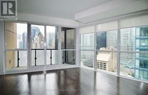 Toronto (Waterfront Communities) condo for rent - A room with a view of the city through large windows.
