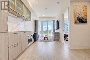 Toronto (Willowdale East) condo for rent - A modern kitchen with wooden cabinets and a large window.